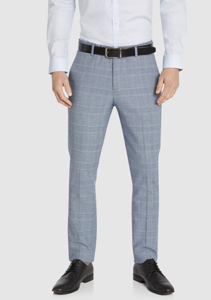 A man wears Connor Sorrento Slim Dress Pant in light blue plaid, a white dress shirt, black belt, and black dress shoes. He stands against a plain background with his hands relaxed by his sides.