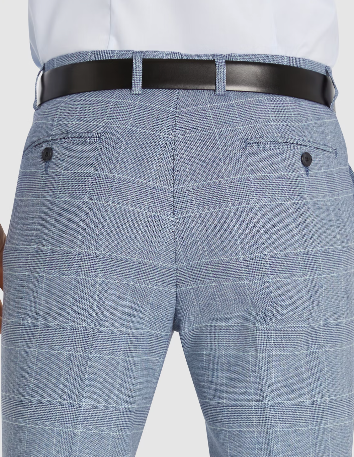 Close-up of the back of a person wearing Connor Sorrento Slim Dress Pant in light blue plaid, paired with a black leather belt and white shirt. The pants feature two buttoned welt pockets.