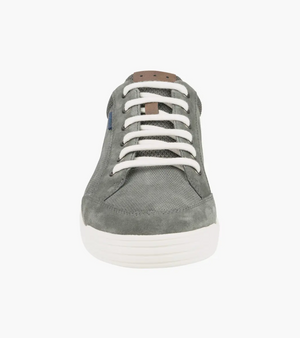 The Florsheim City Walk Lace Sneaker is a stylish gray shoe with white laces and sole, subtle stitching, and a small blue tag on the textured upper. It features a cushioned footbed for unmatched comfort.