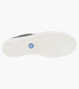 The image shows the sole of a Florsheim City Walk Lace Sneaker with a textured grip. The white sole has a blue circular logo and features "NEVER WET." It offers comfort with its cushioned footbed and stylish appeal.