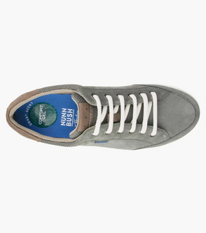 Top view of a gray men's sneaker with white laces and perforated suede leather featuring a blue insole labeled "Nunn Bush Comfort Gel." With a cushioned footbed, brown heel, and sporty design, this Florsheim City Walk Lace Sneaker provides casual comfort for urban adventures.