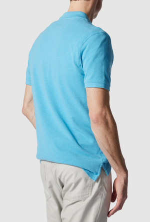 A person in a modern fit light blue Rodd & Gunn The Gunn Polo, made from Australian Cotton, and beige pants stands with their back to the camera. Their short sleeves show their right arm resting at their side against a plain white backdrop.