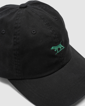 The Rodd & Gunn Gunn Cap, made of durable cotton twill, features a black design with a green embroidered dog logo on the front. It has a curved brim and metal eyelets for ventilation, with the logo subtly placed toward the left front.
