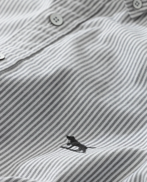 Close-up of a Rodd & Gunn Oxford Stripe Sports Fit Shirt, featuring its gray and white striped 100% cotton fabric. Small buttons enhance the sports fit, while an embroidered animal logo near the hem adds charm. The texture and evenly spaced stripes showcase its quality craftsmanship.