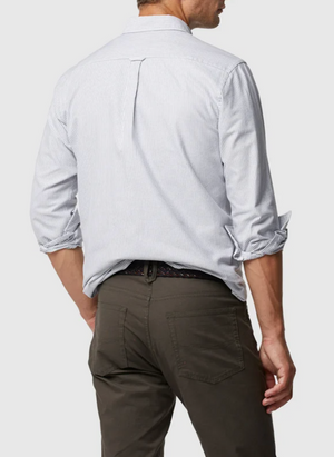 A man, back to camera, wears a light blue Rodd & Gunn Oxford Stripe Sports Fit Shirt in 100% cotton with thin vertical stripes and rolled-up sleeves, paired with dark pants against a plain white background.