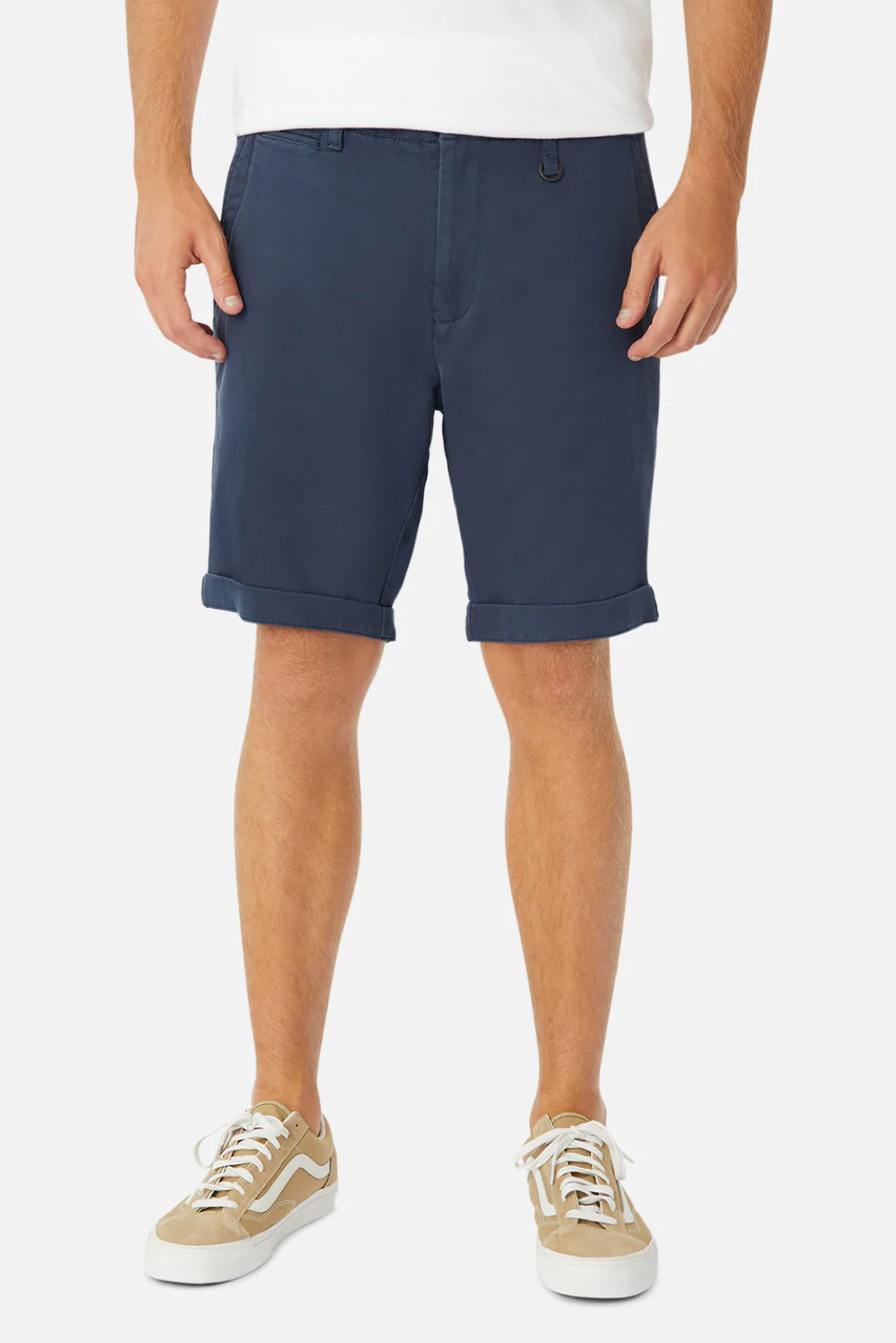 Someone wears Industrie The Rinse Drifter Short in navy blue cotton, paired with a white t-shirt and beige-and-white sneakers, standing against a plain white background.