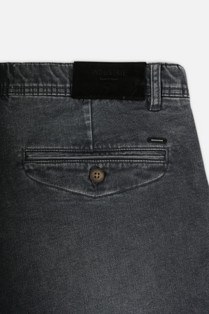 Close-up of dark gray Industrie The Drifter Denim Shorts with a button-closure back pocket. A black "Industrie" label on the waistband adds authenticity, while subtle stitching details elevate these comfortable shorts beyond expectations for fans of Industrie shorts.
