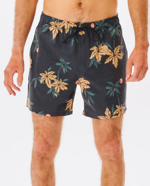 Someone wearing the Rip Curl Sumatra Volley Short, showcasing a vibrant tropical pattern of large leaves and palm trees. Crafted from quick-dry fabric, these shorts include an adjustable drawstring waistband. The plain white background accentuates the lively design.