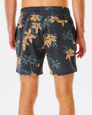 A rear view of a person wearing Rip Curl Sumatra Volley Shorts, featuring a tropical palm tree pattern in beige and green on quick-dry fabric. With an elastic waistband and side pockets, they stand against a plain white background.