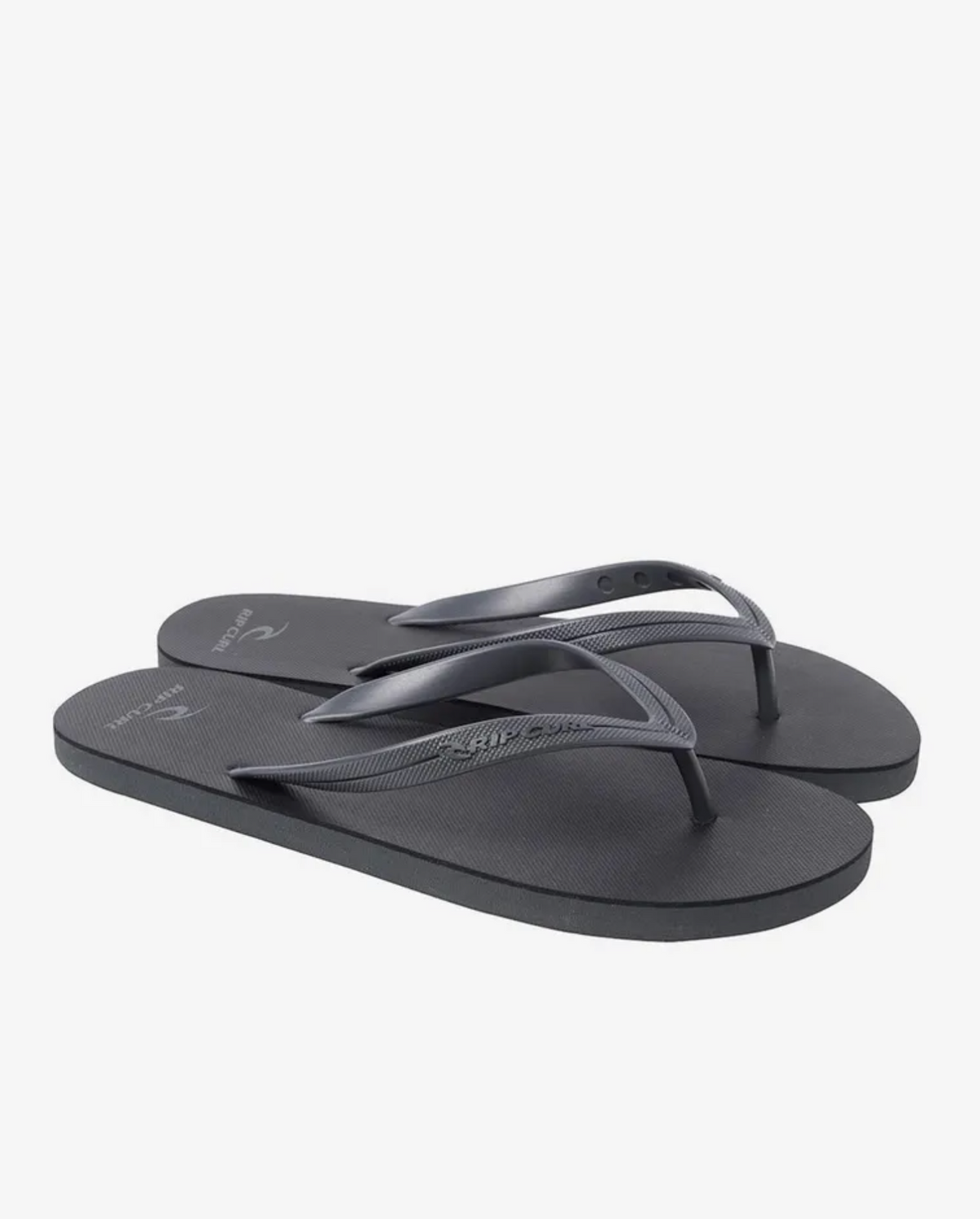 The Rip Curl MC Thongs are black flip-flops showcased on a white background, featuring simple ergonomic molded rubber straps and a textured EVA rubber footbed with a subtle logo.
