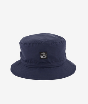 Introducing the Swanndri Murrays Bay v2 Hat: a navy blue bucket hat with a small black patch featuring white text and design, offering a wide, downward-sloping brim and DWR coating for water resistance while keeping its simple, solid color style.