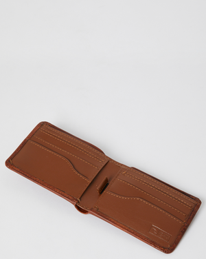 The Rip Curl Corpo RFID Slim Wallet, crafted from brown nubuck leather, is open to reveal multiple card slots and stitched detailing against a plain white background.