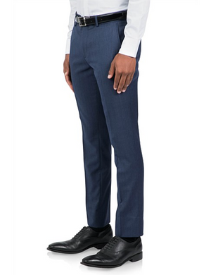 A person in an Uberstone Joe blue tailored suit trouser, white shirt, and black leather shoes. The slim fit legs showcase a sleek design with a black belt, captured from the shoulder to feet in profile.