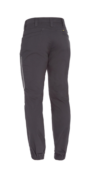 The back view of the Bisley X Airflow Stretch Ripstop Vented Cuffed Pant is displayed. These comfortable dark gray joggers feature an elastic waistband, side pockets, a zippered pocket on the right thigh, and elastic cuffs at the ankles. Made from stretch ripstop fabric, they are designed for durability and ease of movement.
