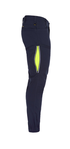 A side view of the Bisley X Airflow Stretch Ripstop Vented Cuffed Pant in navy blue, featuring a neon yellow zipper pocket on the thigh. Made from durable stretch ripstop fabric, these comfortable pants have an athletic fit with elastic cuffs at the ankles and belt loops at the waistband.