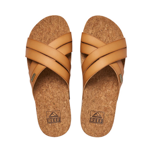 The REEF Cushion Bloom Hi sandals feature tan leather straps and a stylish cork-patterned footbed. With "REEF" printed near the heel, they provide ultimate comfort with a cushion bounce midsole.