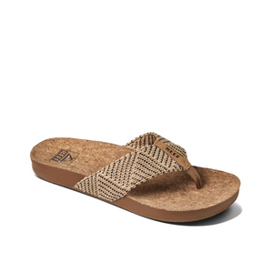The REEF Cushion Strand is a brown thong sandal with a cork-textured footbed and woven geometric strap, featuring a slightly elevated heel, cushion bounce midsole, and arch support for ultimate comfort—a perfect casual summer design.