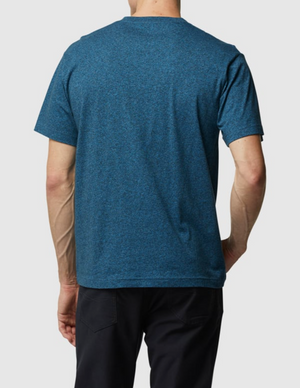 A person is seen from behind wearing the Rodd & Gunn The Gunn T-Shirt in blue, made with Australian Cotton, paired with black pants, set against a plain white background.