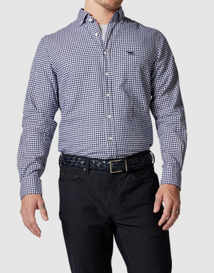 An individual dons a Rodd & Gunn Superfine Gunn Check Oxford Sports Fit Shirt in blue and white checks, composed of 100% cotton, teamed with black pants and a woven black belt. The buttoned-down shirt highlights a casual vibe, though the person's head is not visible in the image.