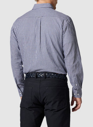 The person is wearing a Rodd & Gunn Superfine Gunn Check Oxford Sports Fit Shirt in blue and white check, made of 100% cotton, along with black pants and a braided black belt, facing away from the camera.