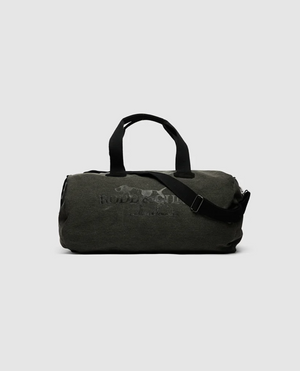 A Rodd & Gunn Double Barrel Duffle Bag in dark green, made from durable cotton canvas with black handles and an adjustable shoulder strap, is displayed against a white background. This sleek design sports a subtle text print on the front, seamlessly merging style with functionality.