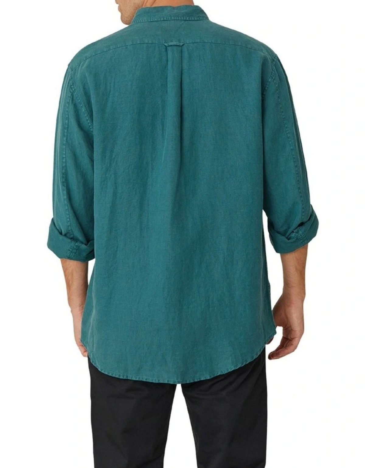 The person is wearing the Industrie The Tennyson Linen Shirt, a relaxed fit teal long-sleeve 100% linen shirt with rolled-up sleeves, paired with black pants against a plain white backdrop.