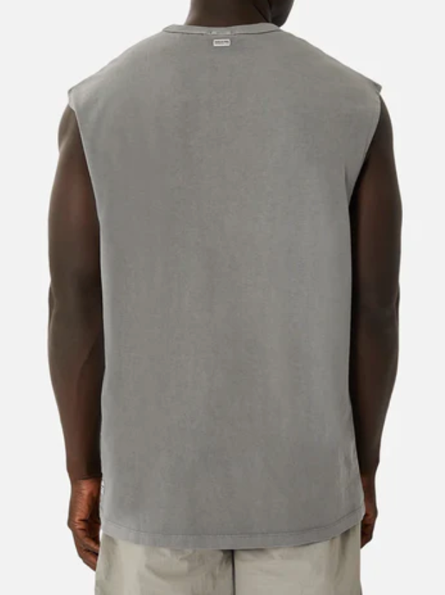 Rear view of a person wearing an oversized Industrie The Del Sur Sleeveless Tee in gray and light-colored shorts, set against a plain white backdrop.