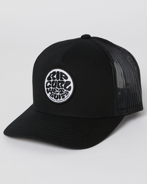 The Rip Curl Icons Eco Trucker cap is black with a round white patch displaying "Rip Curl Wet Suits" in stylized black lettering. Made from recycled polyester twill, it features a mesh back and a slightly curved brim on a plain white background.