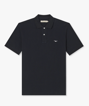 The RM Williams Rod Polo is a black, short-sleeve polo shirt made from cotton pique. It includes a collar and three R.M.Williams branded buttons down the front, along with a small, white Longhorn embroidery on the left chest for a touch of sophistication.