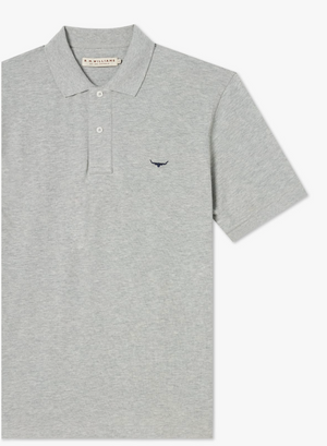 The RM Williams Rod Polo is a gray cotton shirt with short sleeves, a ribbed collar, and a three-button placket. It features a small embroidered longhorn logo on the left chest.