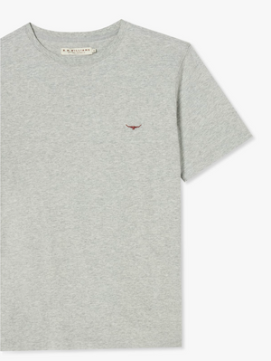 The RM Williams Parson T-Shirt in light grey is a classic cotton jersey short-sleeve option featuring a small embroidered red bull logo on the left chest. It has a crew neckline, and the tag inside the collar reads "R.M. Williams." The minimalist design enhances its simple elegance.