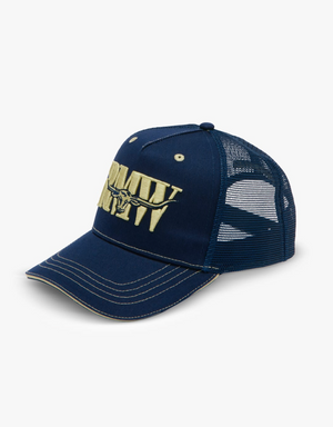 The RM Williams Cremorne Cap features a blue baseball design with white stitching and a mesh back. The front of this trucker cap showcases the letters "ARMY" in large beige text, with a stylized eagle design integrated into the lettering. The cap is displayed against a plain white background.