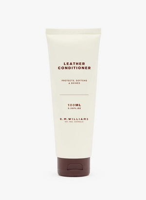A 100 ml beige tube of RM Williams Leather Conditioner features a brown cap. The text on the tube reads, "LEATHER CONDITIONER - Protects, softens & shines" and "100ml 3.38 FL.OZ." Crafted with premium Australian ingredients, it's ideal for maintaining your leather boots. The label also states, "R.M.WILLIAMS - Est. 1932, Australia.