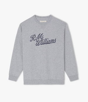 The RM Williams Script Crew Neck is a light grey jumper showcasing navy blue script logo embroidery that spells out "R.M. Williams" across the chest. Crafted from a cozy cotton-blend fleece, this sweatshirt features a classic crew neck design along with ribbed cuffs and hem.