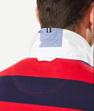 The Gazman Block Stripe Rugby, modeled from the back, showcases its red and navy stripes. This regular-fit jumper features a standing white and blue collar and a small navy loop tag inside. Made from soft cotton, it complements short, dark hair perfectly.