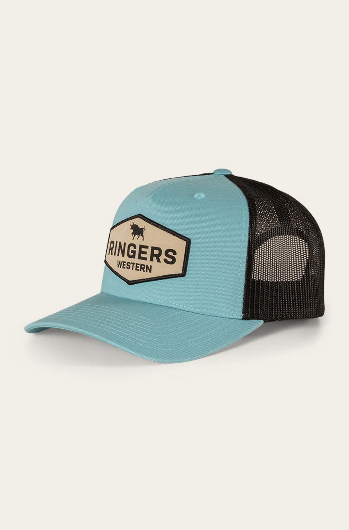The Ringers Western Scotty Trucker Cap features a blue front and brim with a breathable black mesh back, showcasing a beige patch with a bold bull silhouette and the "Ringers Western" logo. It's crafted from durable cotton twill in blue and black.