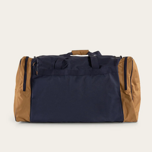 The Ringers Western Rider Sports Bag is a medium-sized sports bag with a navy blue body and tan brown side panels. It features two side pockets with zippers and dual top handles with a padded grip, perfect for your active lifestyle.