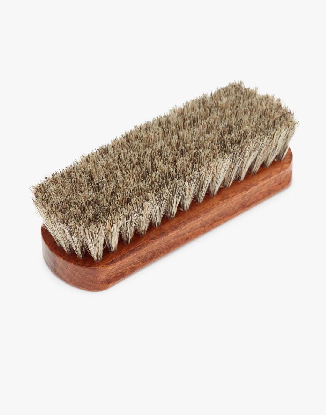 Introducing the RM Williams Medium Brush: a wooden brush crafted for leather boot care. Featuring densely packed, short horsehair bristles and a rectangular shape with slightly rounded edges, this brush boasts a polished wood finish in natural brown.