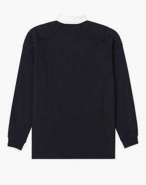 Back view of a long-sleeved, black RM Williams Classic RMW Rugby shirt with a white collar. Crafted from cotton jersey, this shirt features a clean, unadorned design with ribbed cuffs, subtle shoulder panel details, and heritage logo embroidery.