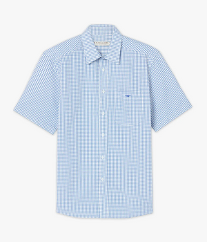 The RM Williams Hervey Shirt is a short sleeve casual shirt featuring a blue and white tiny checkered pattern. Made from 100% cotton, it includes a front pocket on the left side adorned with a small logo above it, a classic collar, and white buttons.