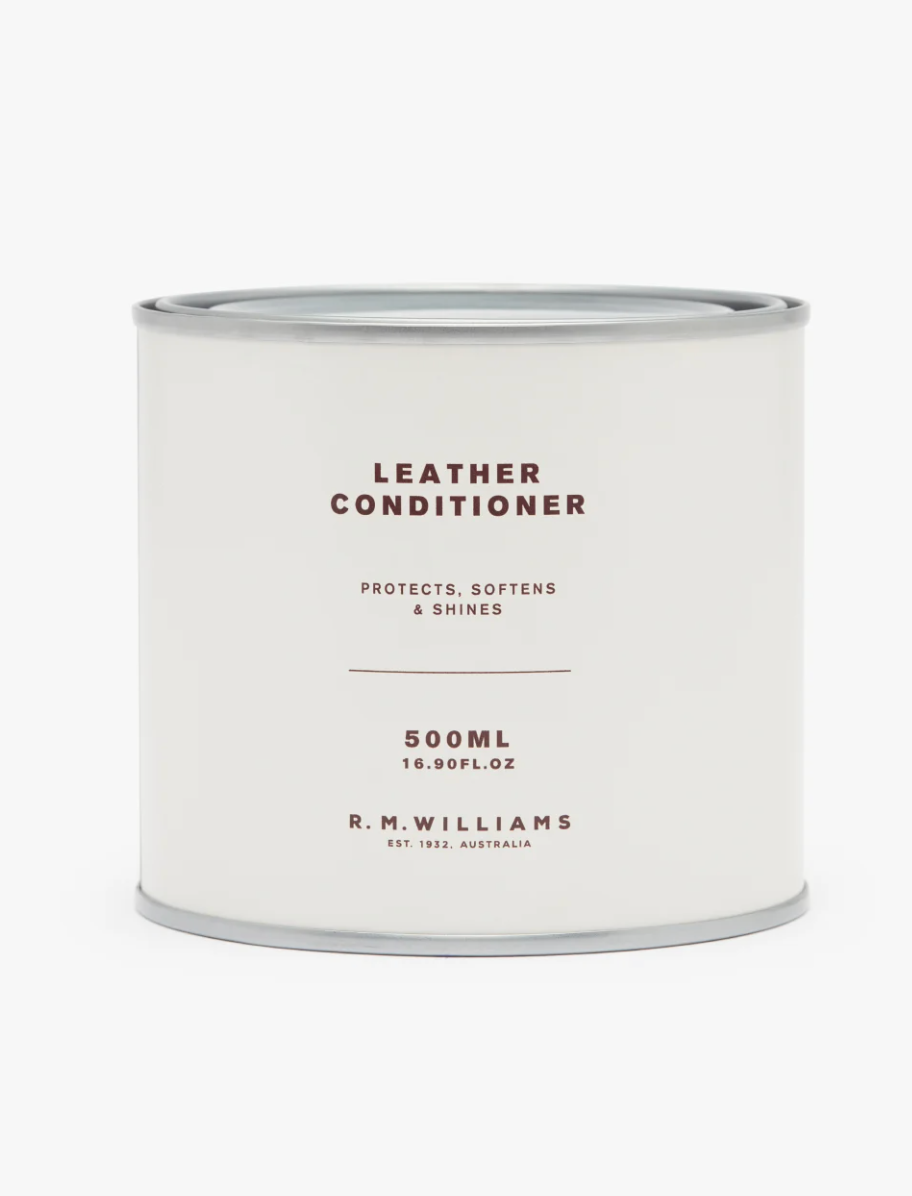 A white RM Williams Leather Conditioner container with a minimalist design. The 500ml (16.90 fl. oz) packaging promises to protect, soften, and shine leather using natural Australian ingredients. The label features the text "R.M. Williams, Est. 1932, Australia" prominently on the front.