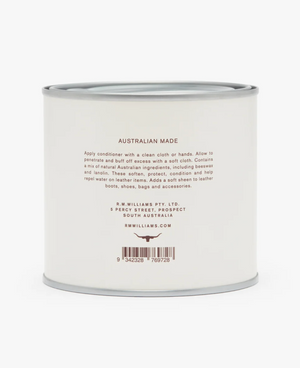 A round, white tin can displaying the text "RM Williams Leather Conditioner" on its exterior. The label reveals that it's crafted using natural Australian ingredients by R.M. Williams Pty. Ltd. Instructions suggest using a clean cloth to apply the conditioner for conditioning and protecting leather items, with a barcode located at the bottom.