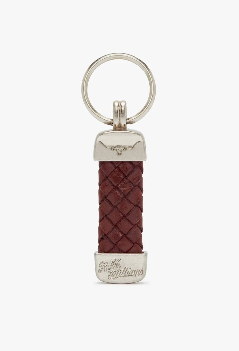 The RM Williams Plaited Key Ring features a silver ring and brass-toned fittings that showcase a beautifully braided brown kangaroo leather strap in the center. The fittings are adorned with Longhorn embossed designs, and an engraving reading "R.M. Williams" is prominently displayed at the bottom.