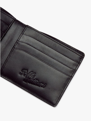 An RM Williams City Slim Bi-Fold Wallet in black is open, showcasing multiple card slots and a larger pocket. Made from full grain leather, the interior is embossed with "R.M. Williams." The wallet appears to be empty, with no cards or cash inserted against a plain white background.