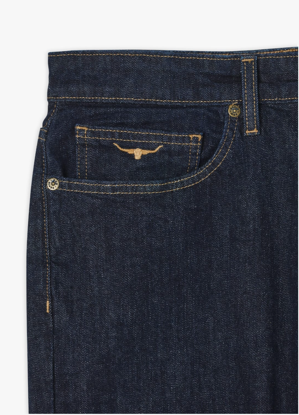 Close-up of the upper section of a pair of dark blue RM Williams Ramco Jeans. The image focuses on the front right pocket area, which includes a smaller coin pocket featuring a distinctive embroidered bull design in yellow thread. The stitching along the seams is also visible on these classic 5-pocket jeans.