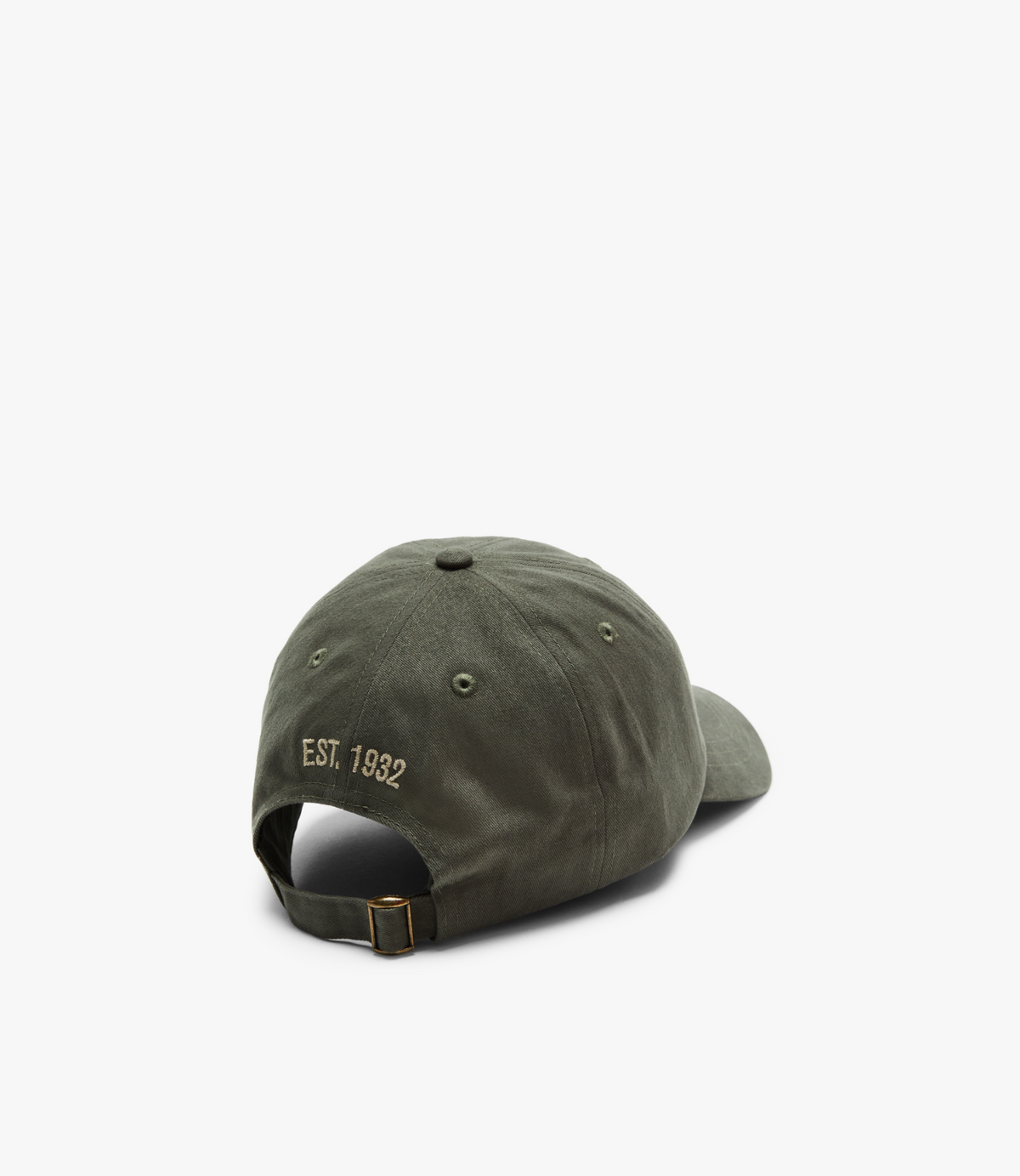 The RM Williams Mini Longhorn Cap in green, made from cotton twill, displays "EST. 1932" embroidered in gold on the back and includes an adjustable buckle strap, all set against a white background.