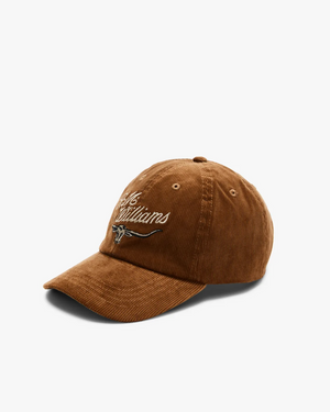 The RM Williams Corduroy Longhorn Cap features a luxurious cotton corduroy texture with an embroidered script and bold longhorn logo on the front, all set against a plain white background, merging classic design with rustic elegance.