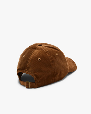 The RM Williams Corduroy Longhorn Cap, made from brown cotton corduroy, is shown from the back on a white background. It features an adjustable strap with a brass buckle, highlighting its subtle elegance.