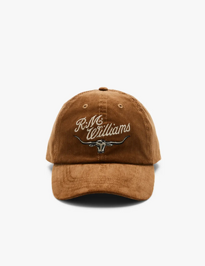 The RM Williams Corduroy Longhorn Cap showcases a brown cotton corduroy design with "R.M. Williams" embroidered above a bold longhorn skull graphic, all set on a plain white background for added distinctive charm.