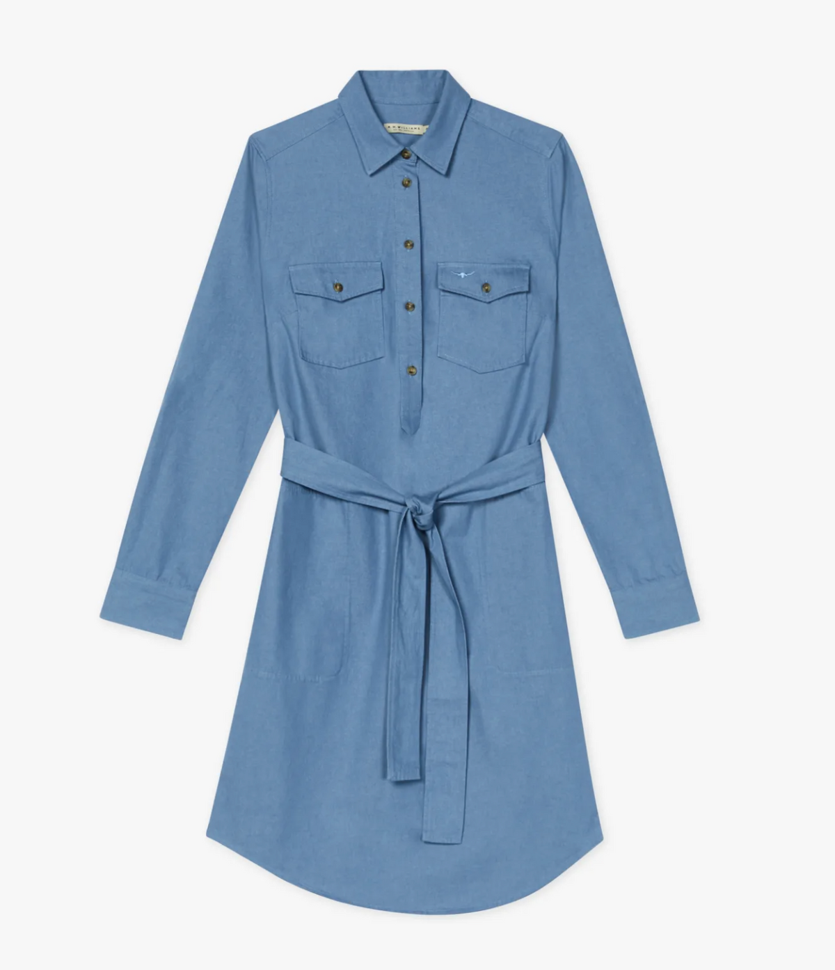 The RM Williams Adare Dress is a light blue chambray shirt dress with long sleeves, collar, button-down front, two chest pockets, tie waistbelt, and a slightly curved hem for a modern look.